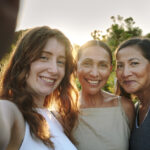 women with different ages taking a photo together