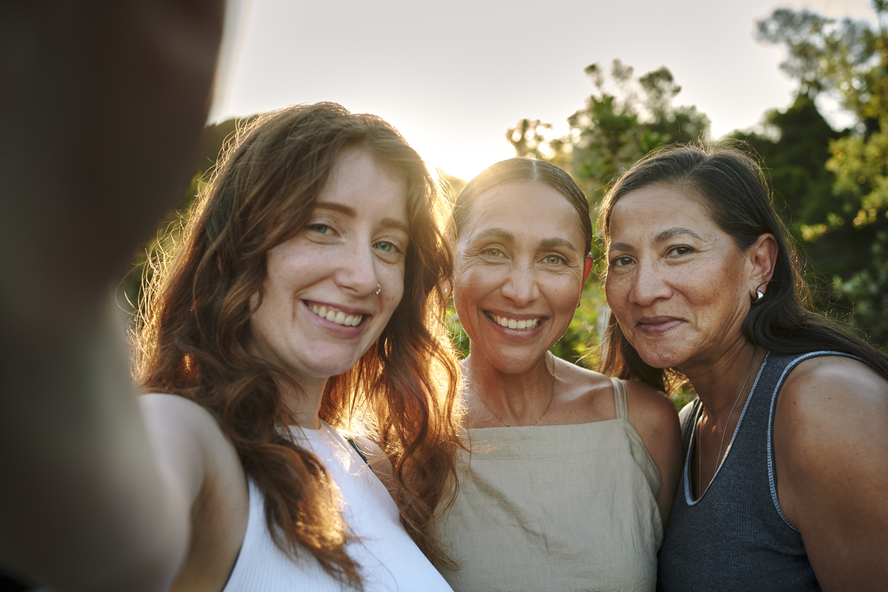 women with different ages taking a photo together