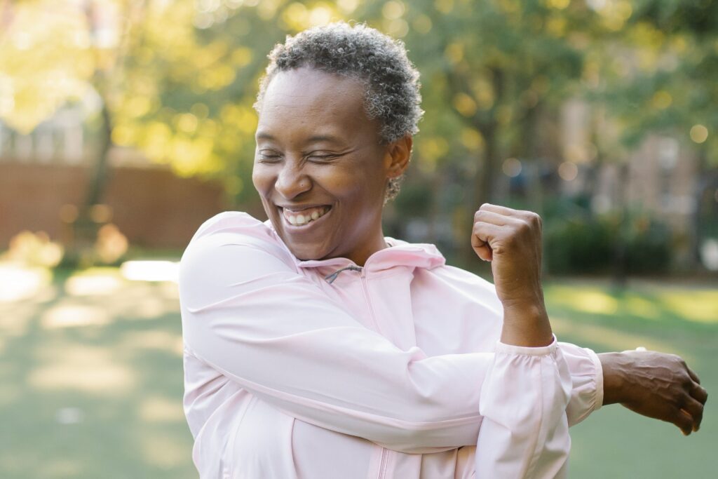 A black woman exercising outdoors.