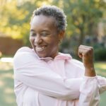 A black woman exercising outdoors.